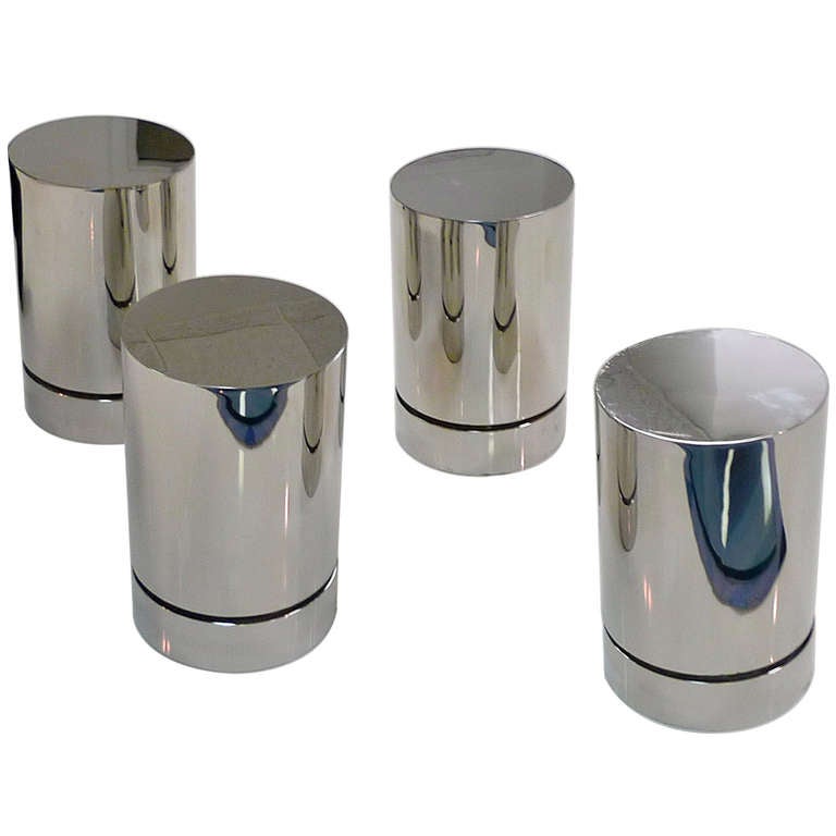 Set of 4 chrome cylinders which are useful either as the base for a glass top cocktail table or to use individually without glass, as occaisionals or display stands.