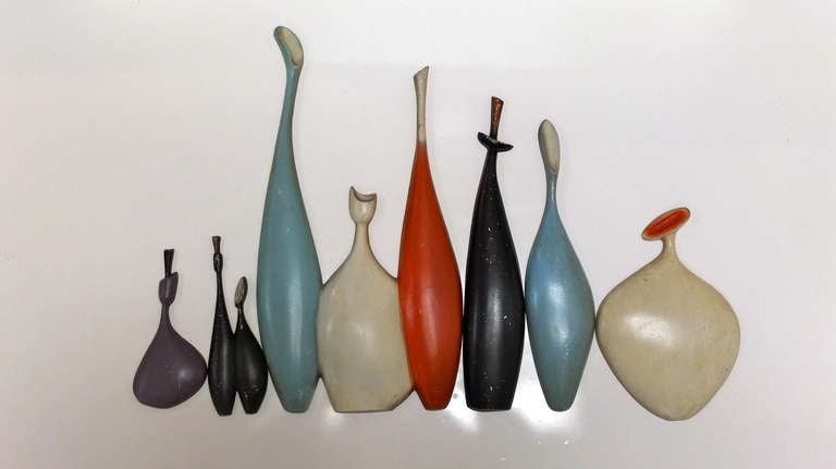 1950's wall plaques made of colorfully enameled cast metal in form of stylized wine bottles.  Various configurations possible as some are singles while others are doubles and triples. Produced by Sexton. Original paint finish.

Additional