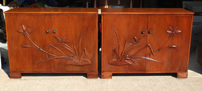 Elegant and well proportioned matched pair of 2 door cabinets having raised Asian style bamboo foliage on the door fronts. Raised on greek key feet.  Doors open to reveal a bisected cabinet space with two adjustable shelves on each side.  Sold only