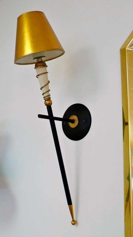 French 1950's long torch sconces, a design influenced by French colonialism in Africa.