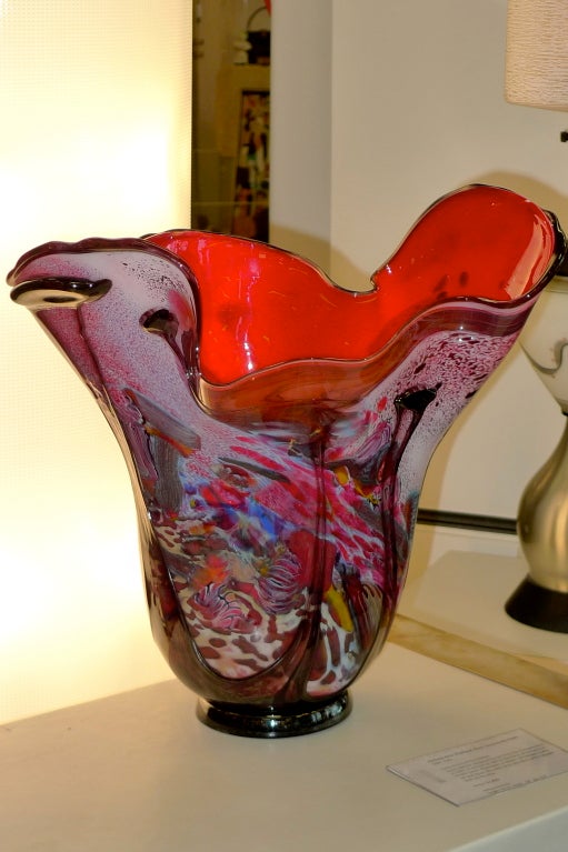 Vibrant hand blown art glass vase by California artist, Lucy Chamberlain executed in an explosion of purple, magenta, red and pink.