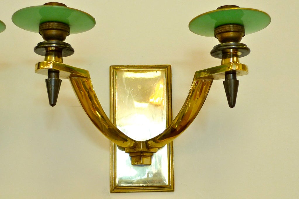 Handsome heavy pair of gilt bronze wall appliques with gunmetal embellishments, brass rectangular wall mount and green glass-like plastic bobeches.  These are signed and numbered but the imprint on the casting is indecipherable.