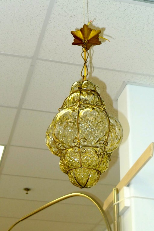 Gorgeous vintage Murano bubble glass cage lantern pendant.  Includes original star shaped ceiling canopy.  Glass has slight amber tint. These look great hung in clusters.  We can adjust the drop to your needs. Takes a single 60 watt bulb.

We have