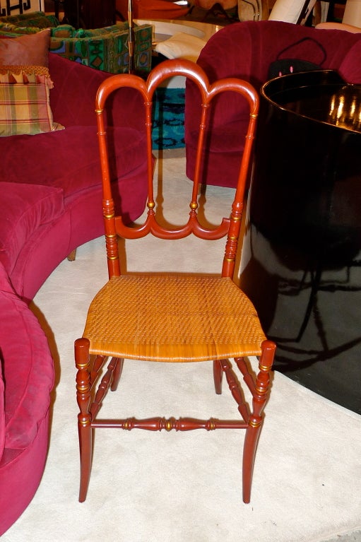 Elegant tri-arch Chiavari chair in deep red satin lacquered beech wood (no metal parts whatsoever)with subtle gilt trim and woven seat.