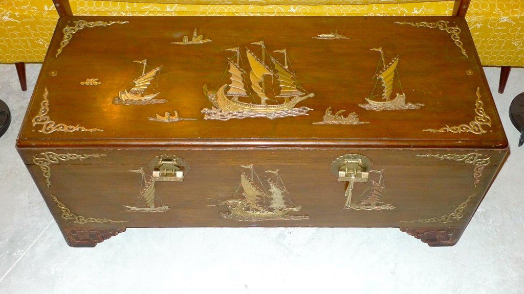 Most unusual large camphor lined teak wood trunk extravagantly adorned with decorative brass & copper decorations and inlay depicting Hong Kong harbor junk in full sail with water flora and fauna.  Note the unusual brass locks with keys.  Mid-late