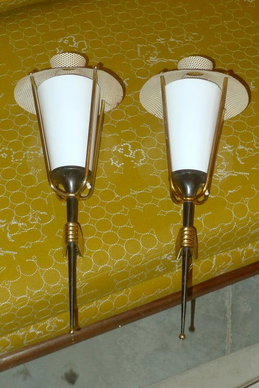 A matching pair of French 1950's torchere lantern sconces produced by Arlus, design attributed to Mathiue Mategot.
Gunmetal anodized brass and polished brass wall mounts.  Perforated metal hat shaped tops are in their original cream enamel.

New