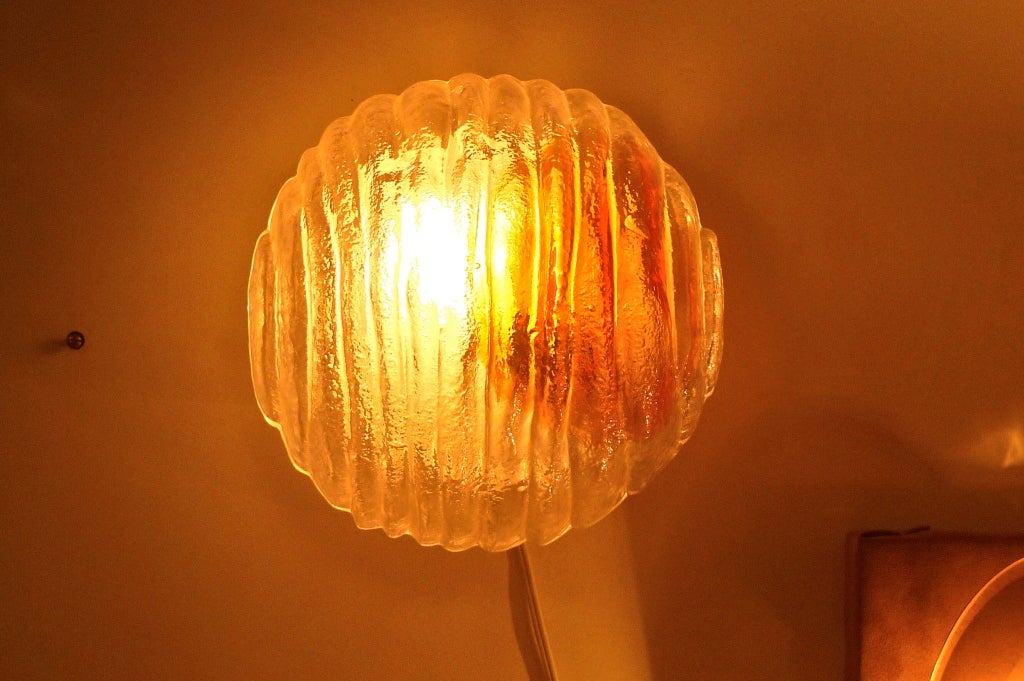 A molded textured glass wall sconce or flush mount ceiling light by Mazzega of Murano, Venice, Italy.  Opaque glass with orange, yellow and hot white tones.  See companion Mazzega Brutalist formed glass sconces in our separate listing.

Can be