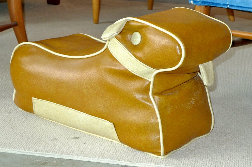 Vintage 1950's two tone vinyl foot stool in form of a dog (some say a Scottish Terrier) but I think it is a dachshund with short ears and tail.  
In nearly like-new condition after all these years.