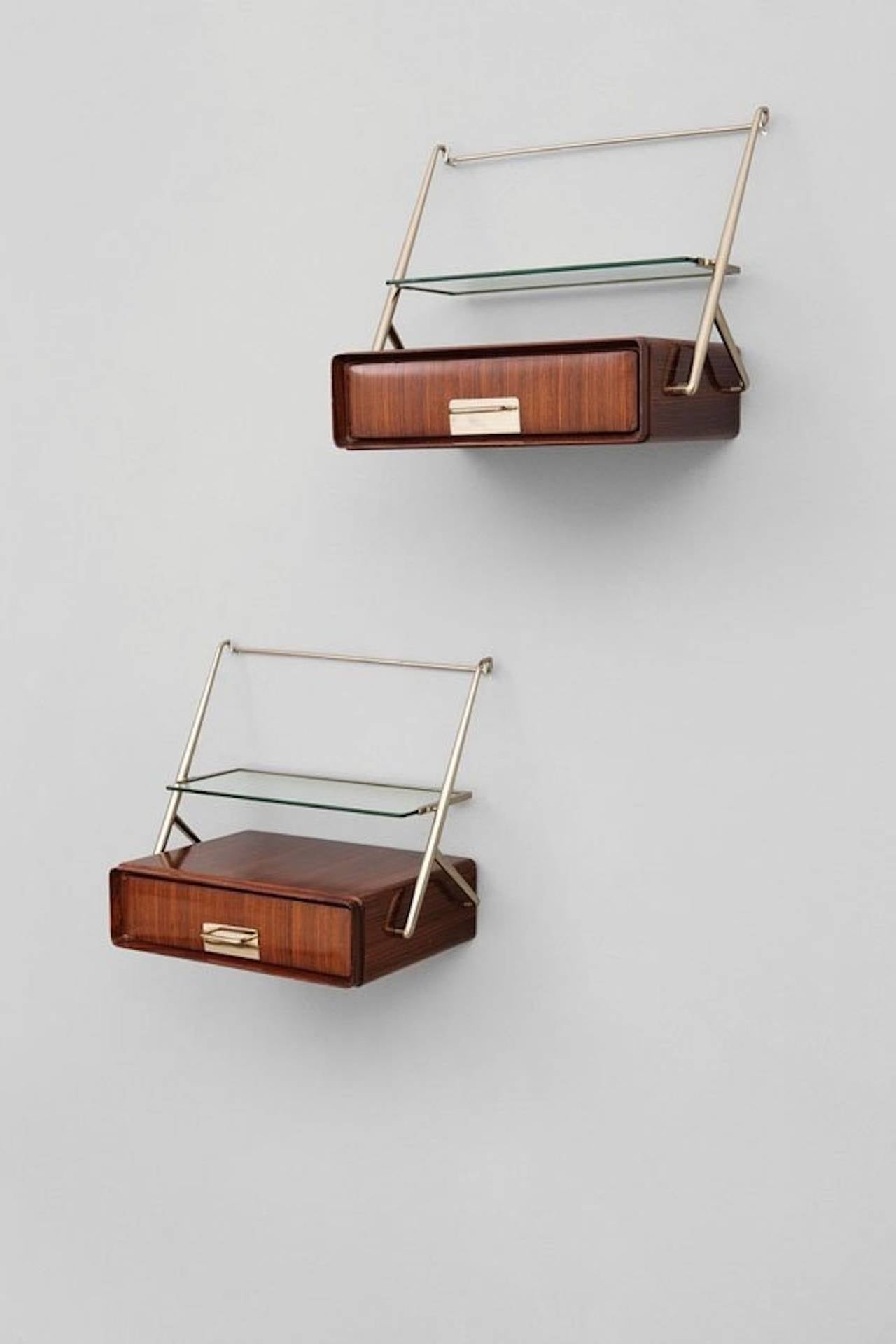 Pair of wall or headboard mounted floating bedside cabinets by Silvio Cavatorta, circa 1953. 

Rosewood, nickel-plated brass, cut crystal.

See image number 3 for example of how they were mounted to a headboard.

Literature: Il Mobile Italiano