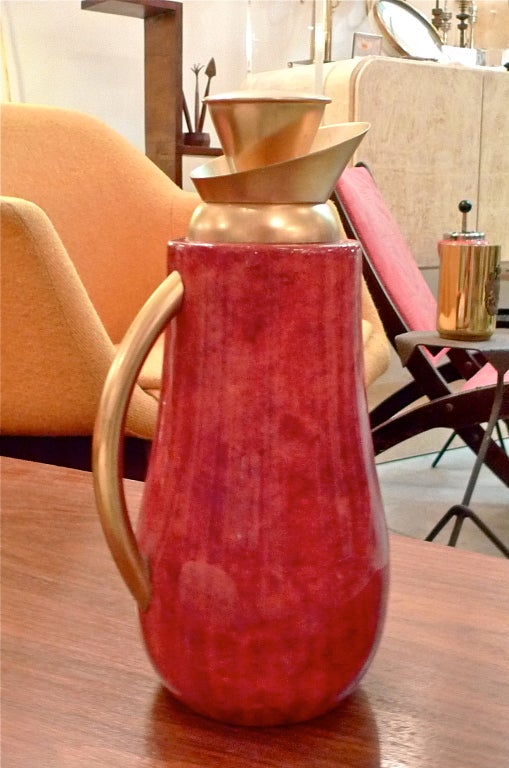 An Aldo Tura designed mercury glass lined carafe in formed wood shell wrapped in dyed goatskin and lacquered.  Round Tura label present on underside.