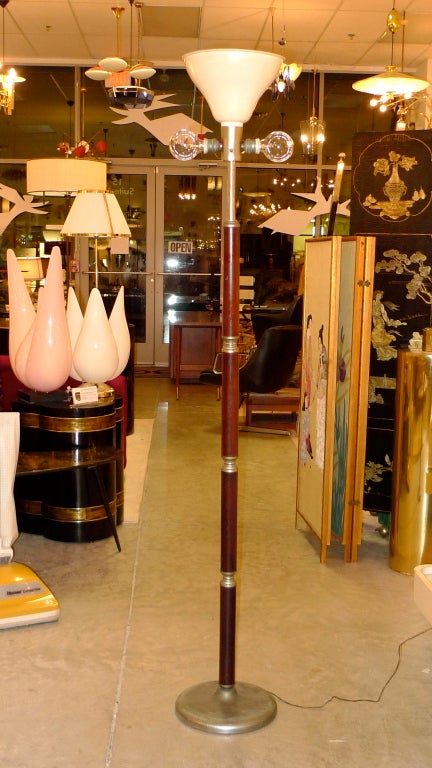 Stunning 1950's Italian floor lamp with the art deco stylings prevalent on the ocean liners of the era with multiple segments of mahogany and satin nickel finished brass and enameled aluminum uplighter cone.