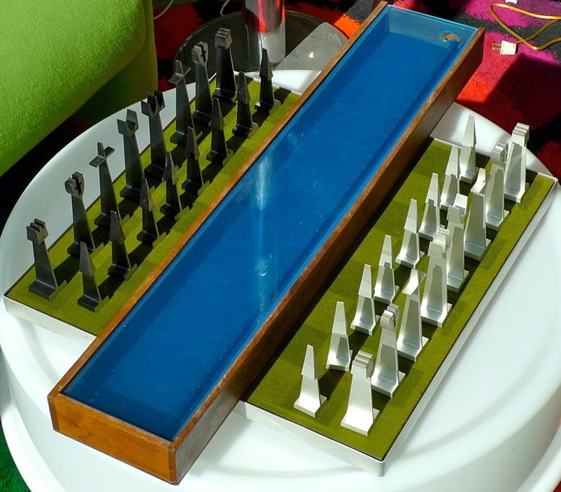 Rare and collectible chess set designed by Austin Cox of Austin Enterprises commissioned by the Alcoa Aluminum Company in 1962. The individual pieces are in distinctive modernist form and made of extruded aluminum, each stamped on the bottom, and
