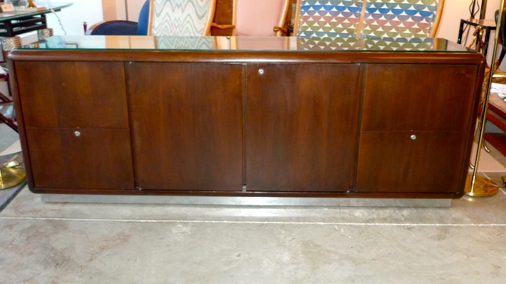 Solid as a rock, 1970's vintage solid walnut credenza with space-age waterfall edges from the Astro Series by Gianni Designs for Office Suites, Inc. (Chicago).  Two center doors open to reveal a large open space divided horizontally by a single