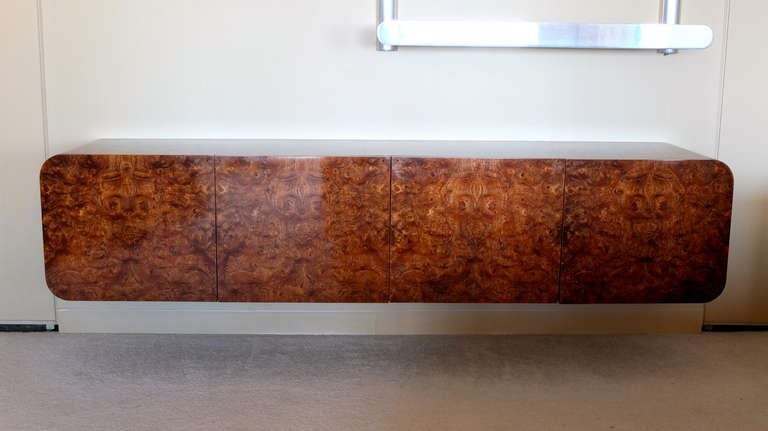 Seven foot floating wall-mounted credenza/buffet from the Pace Collection.  Dark burl elm 4 door cabinet with beautifully glowing finish on five sides with rounded edges.  

Mounts to wall simply by being lifted and lowered onto a 4