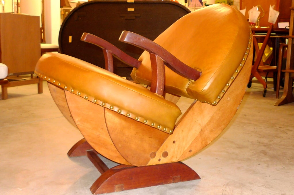 An unusual craft made wood and leather rocking chair in the form of a three-quarter sphere (in other words, PacMan! Or Mrs. PacMan).  Made in the late 1960's by a local woodcraft artisan from the South Shore of Boston.  Newly upholstered in soft