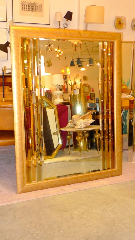 Pop the champagne and put quarters in the vibrating bed, and look at how gorgeous you are in this va-va-voom sexy (and elegant) vintage mirror, attributed to Mastercraft.

Central beveled rectangular mirror is flanked by three slim lengths of