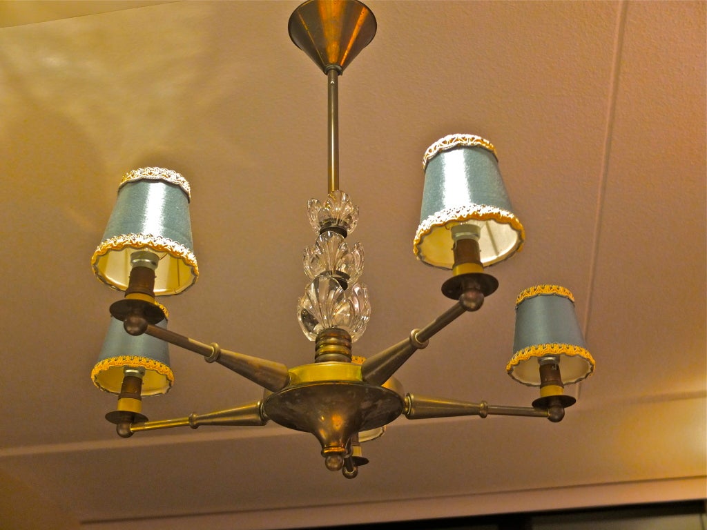 !950's French bronze and crystal five arm chandelier by Maison Jansen, in the manner of Gilbert Poillerat.

See detail Image 9 and 10 for the companion sconces of which we have a total of five pairs available.  See BG's 1stdibs listing ref: