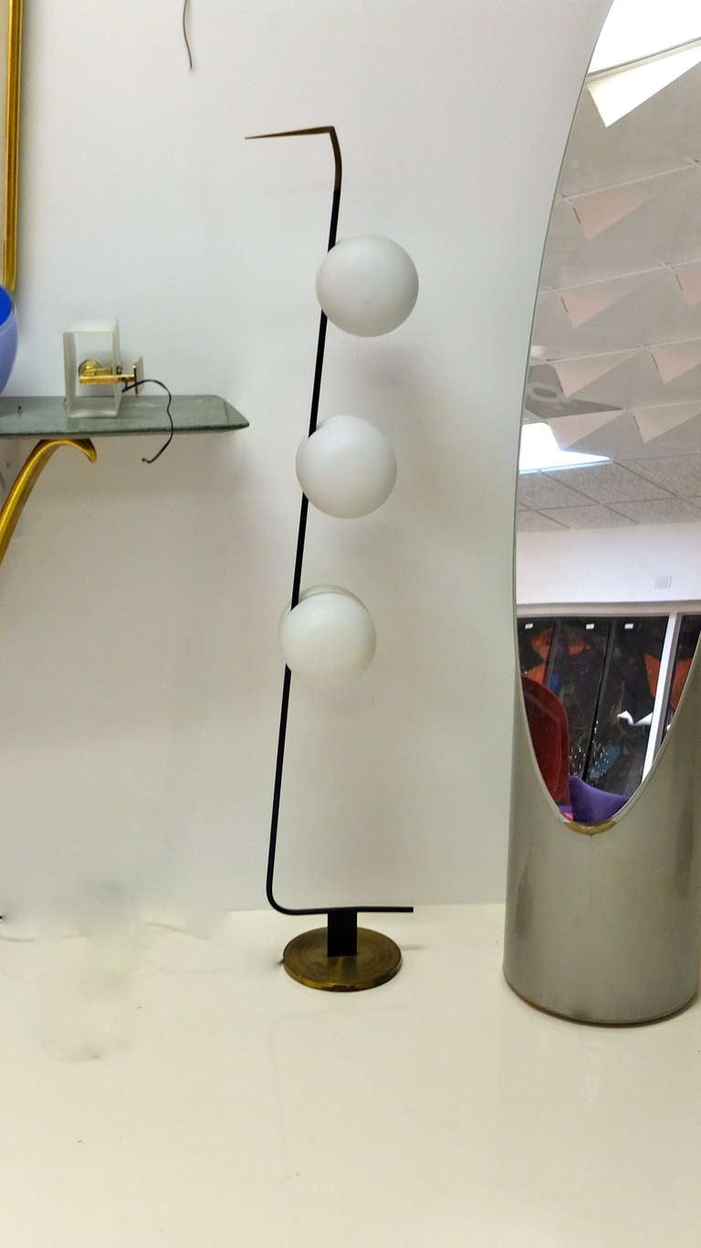 Rare floor lamp from 1950's France by Lunel with six satin glass bun shaped demi-globes on a Z shaped blackened steel arm with brass base and embellishments.

Double bulb sockets inside each 