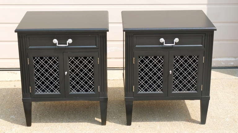 Pair of vintage bed side cabinets by Henredon from Paine Furniture, refinished in satin black with silver wire mesh grille doors and hardware.