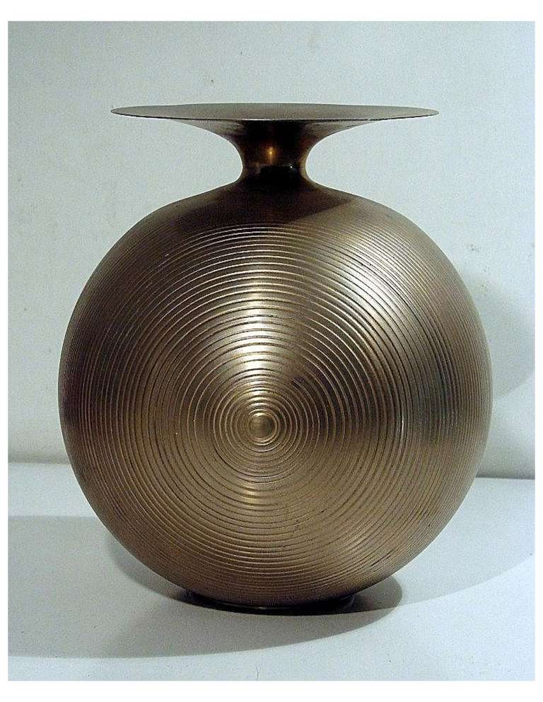 Late 1960's/early 1970's Italian brass orb-form vase with concentric circle- spiral engraving on one half.