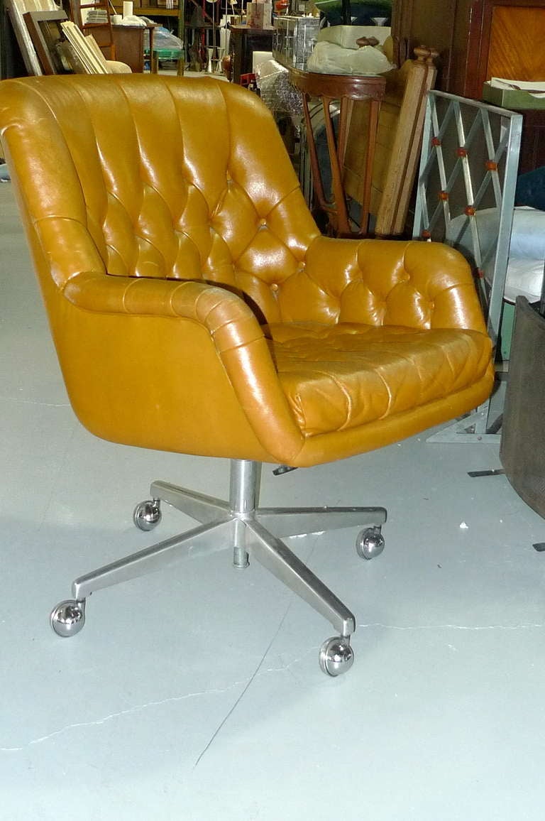 Tufted caramel leather executive office chair by Edward Wormley for Dunbar.  Four star aluminum base on chrome ball casters.  Tilt, swivel, height adjustable.