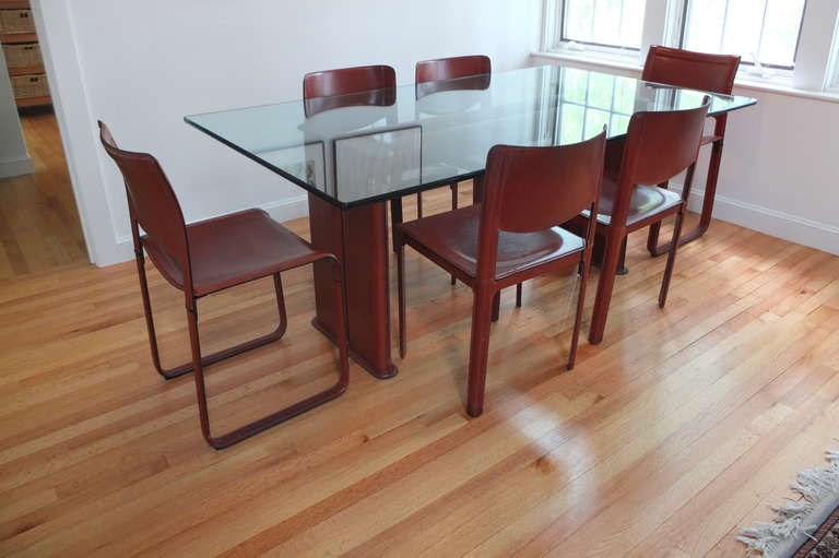 Saddle stitched leather dining table and six dining chairs embossed MatteoGrassi, Italy from the 1970's.

Gorgeous patina to leather.

Structurally excellent.

Available with or without glass top.

The table is called 