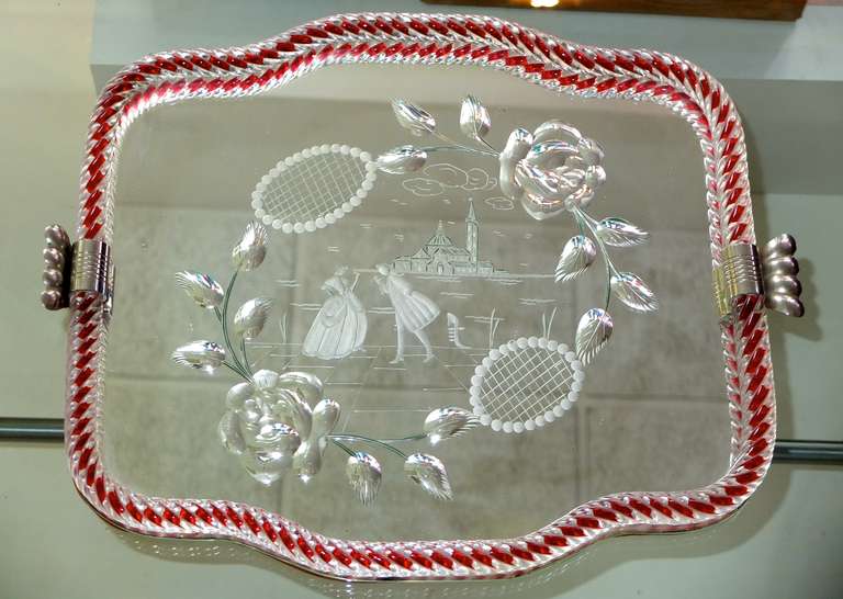 Beautiful Italian serving or vanity table tray edged in Murano glass rope embedded with red, the mirror etched with Venetian figures and flowers done in the style of Luigi Brusotti and Gio Ponti.