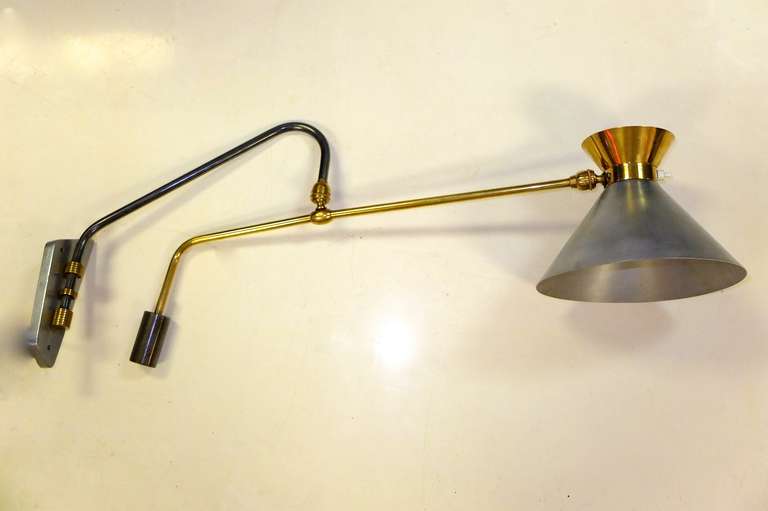 French 1950's counterbalance swing arm wall lamp produced by Maison Lokiec with aluminum and brass diabolo shade which is 10" diameter and 10.75" tall. 

Modernist styled mounting plate is 7" x 4". BG can fabricate a custom size