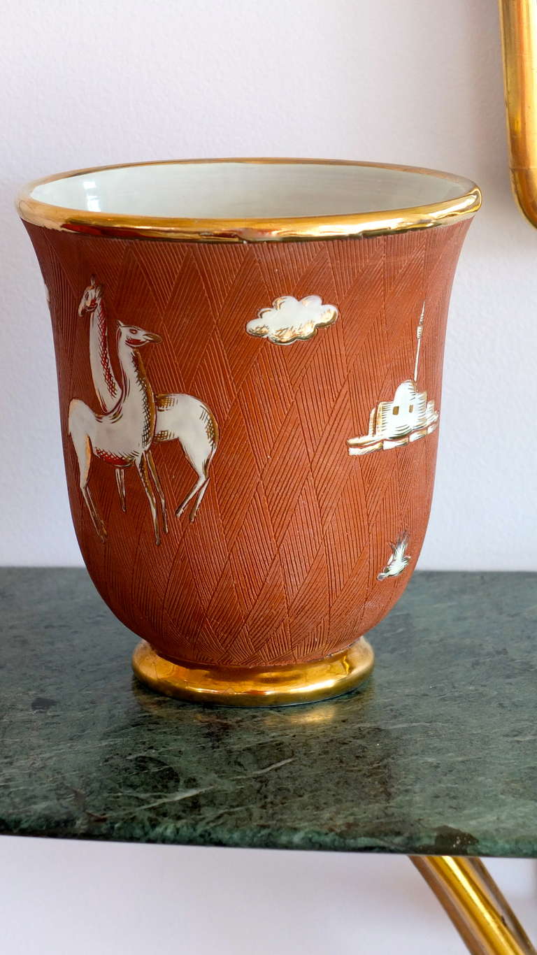 1930's Italian Art Deco vase in the manner of Gio Ponti for Richard Ginori.  Gilt edged mouth and base, hash mark etched terra cotta clay with white glazed enamel floating images suggesting scenes of North Africa....probably Libya which was an