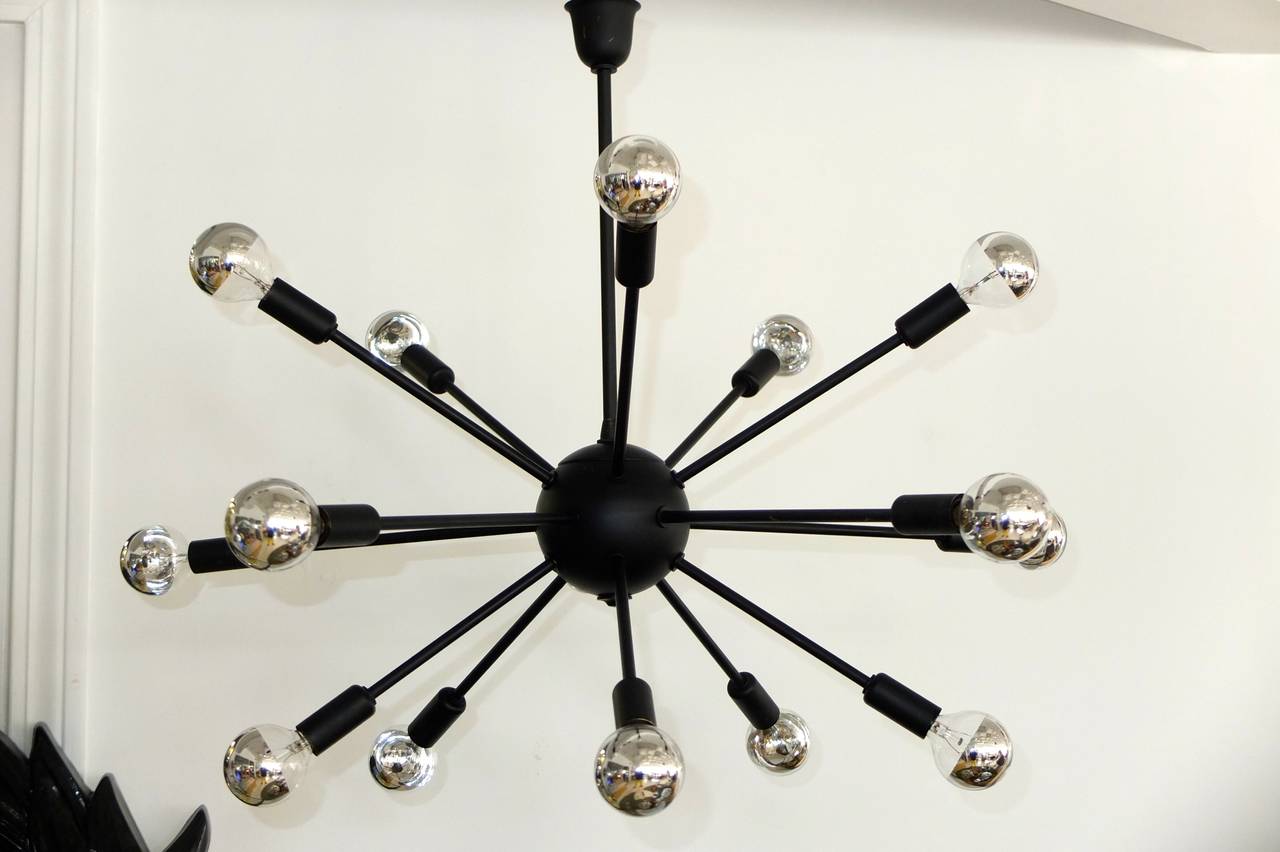 Vintage 1950's American Sputnik chandelier, probably by Lightolier, in solid brass but which has been enameled in matte black. I'm not sure if this was an optional finish available from the manufacturer or whether it was done later.  We have left