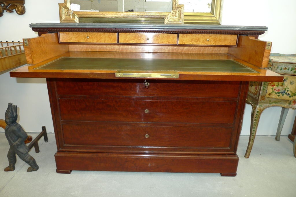 Antique French mahogany Louis Phillippe commode with drop-down desk / secretaire with marble top and tooled leather writing surface. Working locks and keys.  Four drawers including secret bottom drawer.