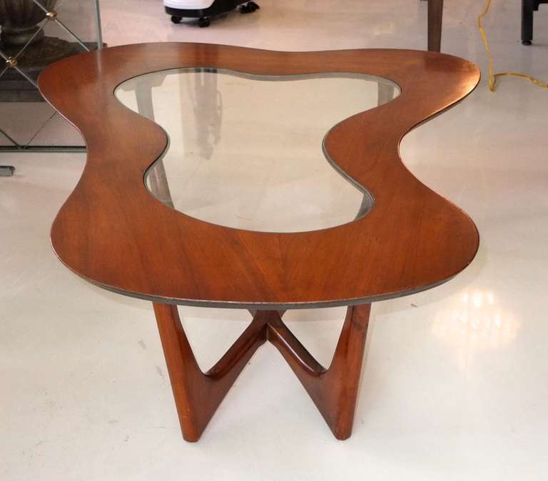 Organic modernist biomorphic coffee table made of solid walnut by Erno Fabry of Fabry Associates. Glass insert top sits flush with wood.