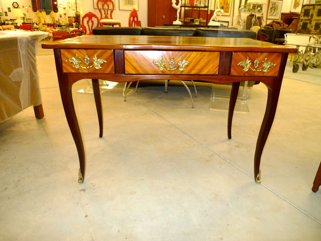 Lovely period Louis XVI writing table with leather top and bronze mounts.<br />
<br />
Kingwood (case & drawers) and Purple Heart (legs).