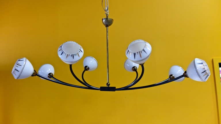 French 1950's Eight Arm Iron Chandelier with Unusual Milk Glass Globes For Sale 2