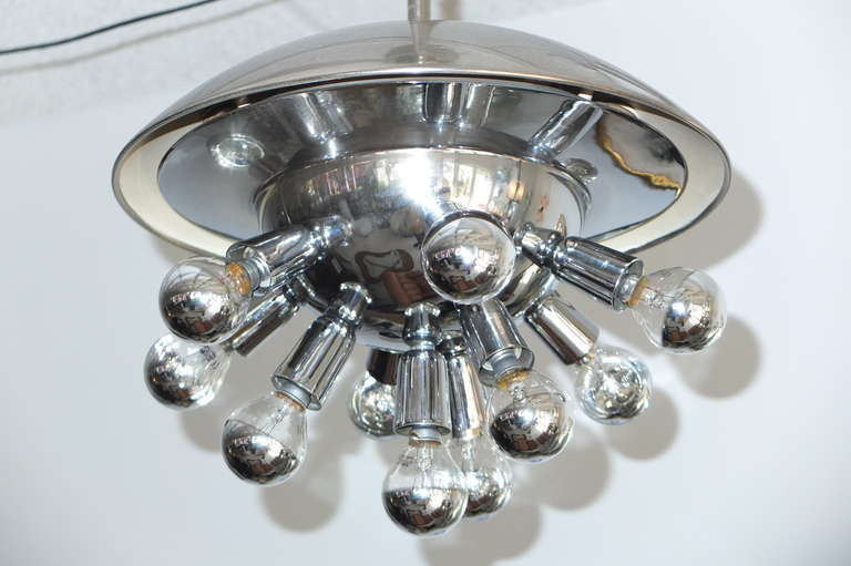 The high level of quality is apparent in the heft and skilled metal craft of this unusual pendant light fixture by Stilnovo Milano (see original brand mark under dome).  Created from nickel plated brass and chromed steel..  Original canopy which is