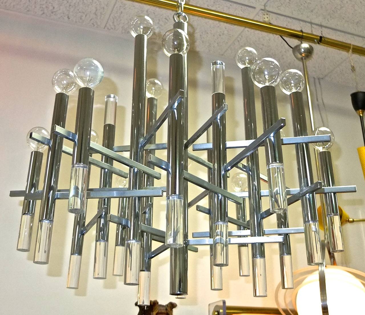 SATURDAY SALE Boston Design Center

Modernist chandelier by Gaetano Sciolari in asymmetric geometric brutalist design with vertical tubular chrome stems with cylindrical lucite bottom finials, and horizontal; brushed stainless rectilinear