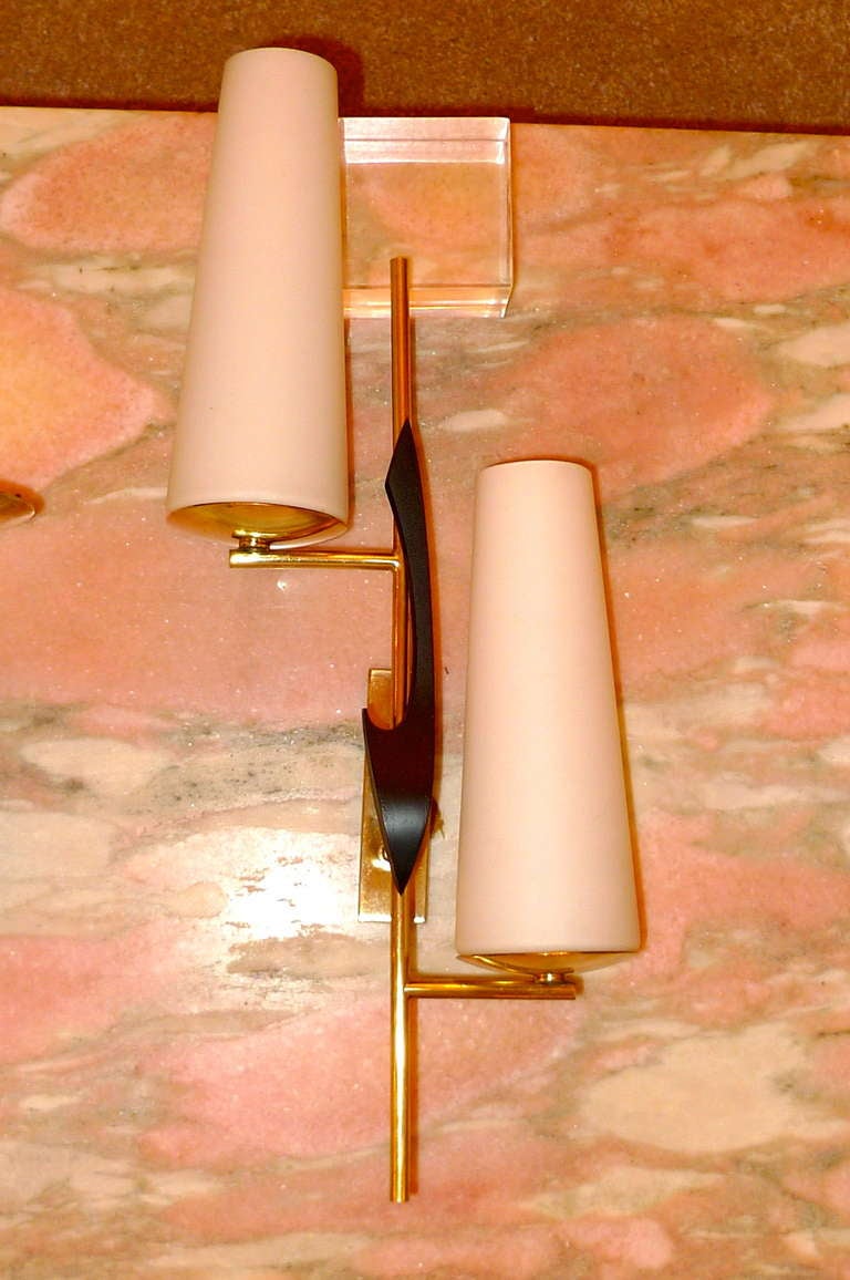 Generously proportioned French modernist wall sconces by Arlus with ebonized wood abstract embellishment and tapered opaline glass shades. Rewired.

Price is for both pair.

Also available as a single pair for $3500.