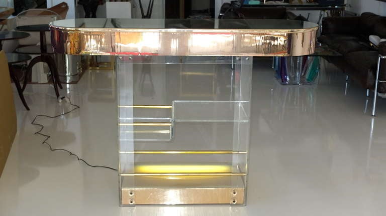 Gorgeous 1970's freestanding bar made of clear Lucite and gold tambour acrylic mirror tile with a mirrored racetrack oval countertop and illuminated base.  This is an actual prop from the movie 