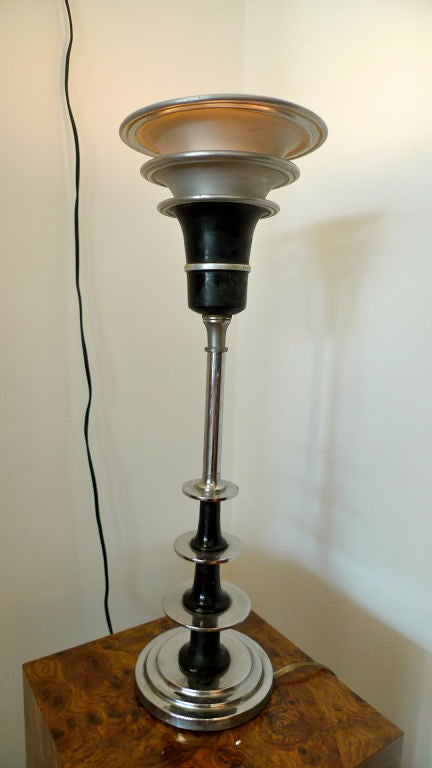 Fabulous chrome and spun aluminum Art Deco table lamp with stepped base and skyscraper radio tower vibe.<br />
<br />
See companion sconce posted separately.