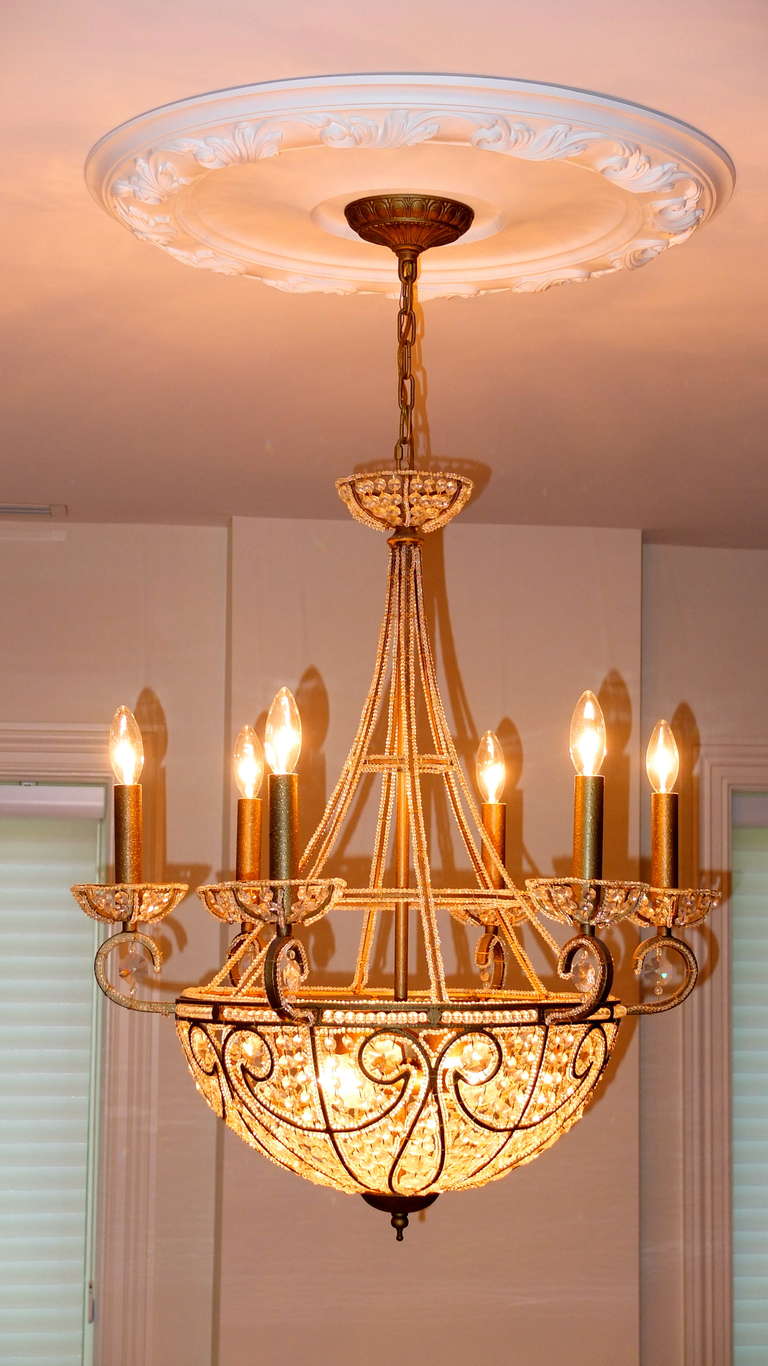 SATURDAY SALE Oct. 2018

Elegant and glamorous French Empire style chandelier with glass crystal beaded 'bag', bobeches and canopy and double strands of smaller beads outlining the frame of the 'tent'.