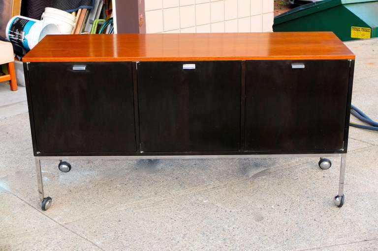 SATURDAY SALE Oct. 2018

Harvey Probber (1922-2003) three door sideboard on chromed steel square bar base with four chromed ball casters.  Black case, walnut top. Black interior with three compartments with moveable pegged vinyl wrapped shelves and