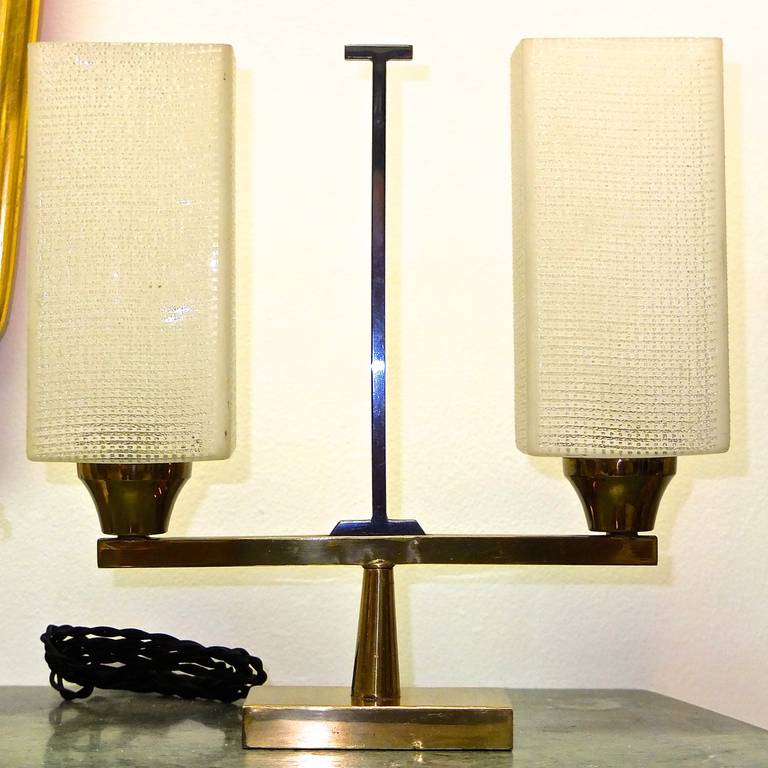 Original 1950s French table lantern in modernist form made of solid brass and having gunmetal finish on the upright handle.  Textured square cylinder glass shades. Original bayonet bulb sockets to be converted to standard E12 candelabra sockets