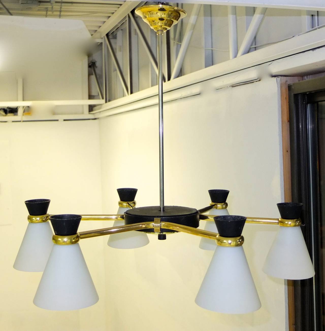 Lovely French 1950s chandelier which is easily adaptable to be a flush mount ceiling fixture.....a black enameled hub around which are three brass double arms each of which hold two diabolo shades made of opaline glass and enameled aluminum.  Each