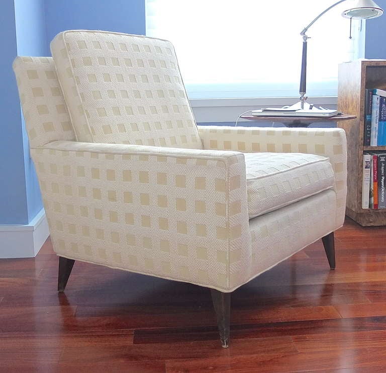 Early 1950's comfortable arm chair with loose seat and back cushion and walnut tapered legs.