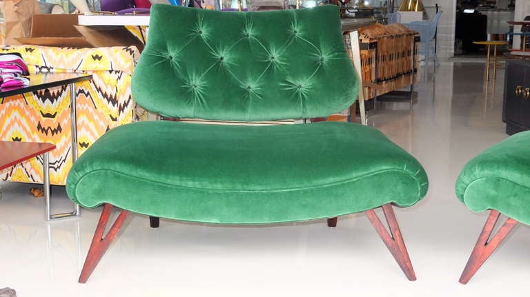 Fabulous pair of Grosfeld House slipper chairs with button tufted back rests and nearly bench wide seats on walnut stained V form legs.  These have been totally restored with new springs and foam and recovered in emerald green velvet.