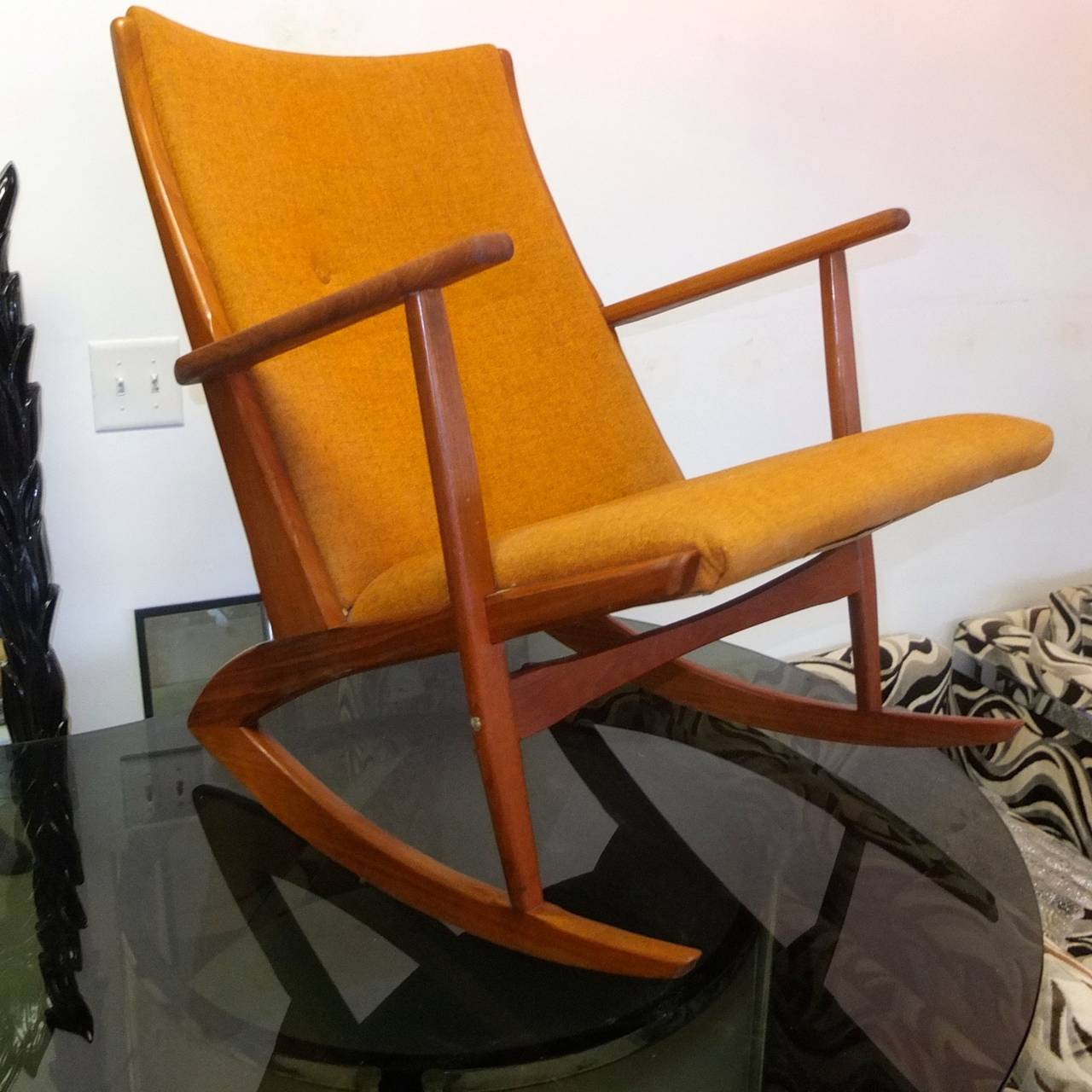 Danish teak rocking chair designer by Holgar Georg Jensen* part of the Kubis collection for Tønder Møbelværk Denmark, 1958.  Original upholstery very clean. Stylish boomerang design.

Arm rest height ~23 inches.

*no relation to the
