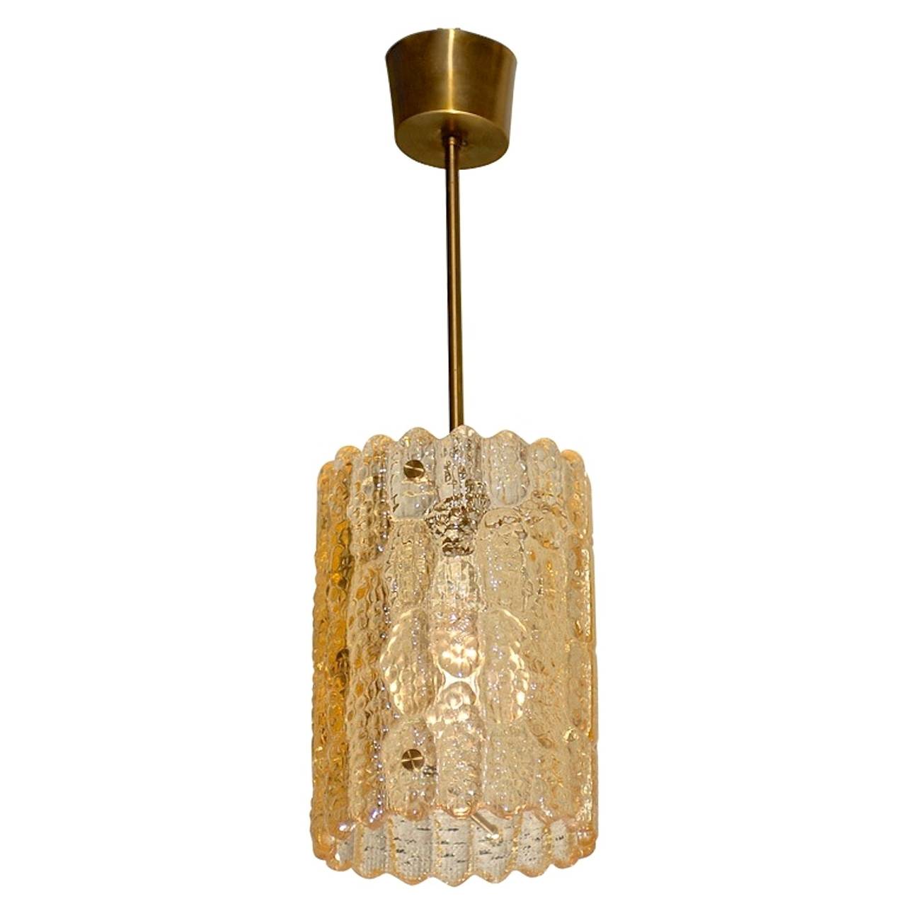 A Swedish crystal pendant light with brass hardware by Carl Fagerlund for Orrefors, Sweden.  Late 1940's - early 1950's.

The glass in this particular example happens to have a golden amber tint as opposed to clear.

Total height including