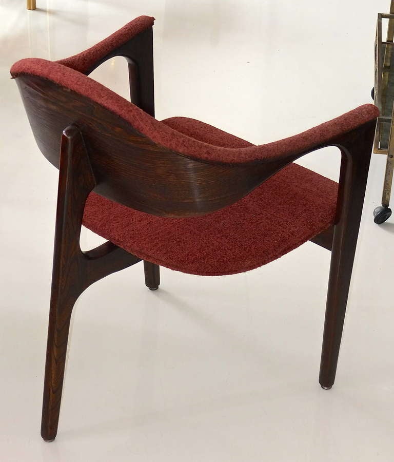 Unusual mid-century modern walnut armchair with three legs, two in front, one in the back.

In original nubby wool upholstery.

Recently refinished in dark walnut.

Manufactured by Carolina Seating Company (CSC) circa 1967..

We can recover