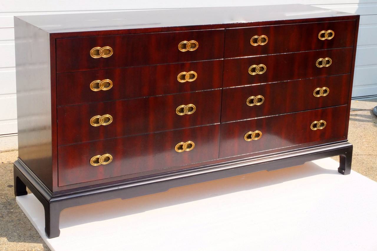 Beautiful vintage Henredon long low chest of drawers in the style of Michael Taylor for Baker's Far East Collection.  Polished mahogany elevated on Ming style base with legs.  Inset brass pulls styled like the 'infinity' symbol.  Drawers glide