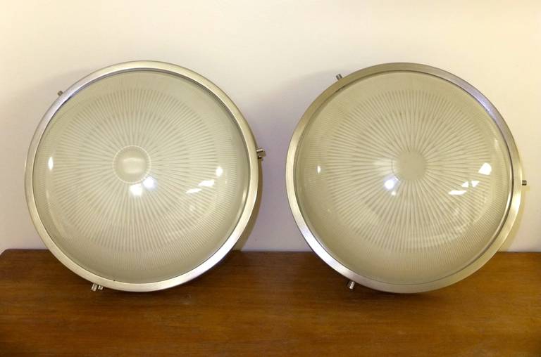 Pair of ceiling flush mounted lights designed for Artemide, Italy by Sergio Mazza, one of the founders of Artemide.

The domed holophane glass is textured on the inside with a stamped starburst pattern.

Frames are brushed nickel.

Price shown